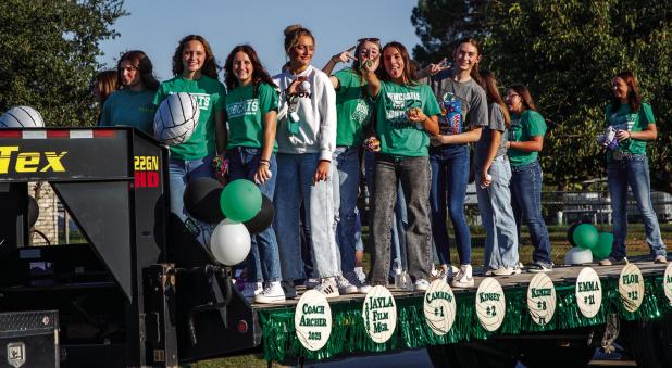 NHS Varsity Ladycats Volleyball team wave to the crowd during the Newcastle High School Homecoming Parade on Friday. Photo by Will Sadler