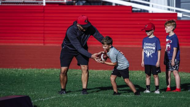 OISD coaches give individual attention to camp attendees, each coach passing on skills and making sure campers are still having fun to build excitement for football. Photo by Will Sadler