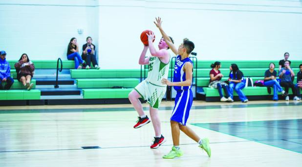 NJH Bobcat #35 Leon Creel with a break away from a Longhorn defender for a layup. Photo by Will Sadler