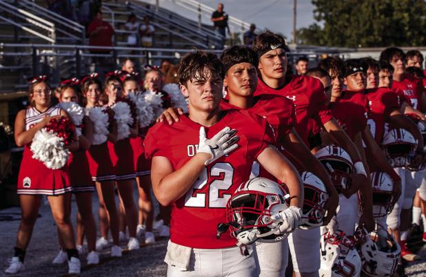 OHS Cub Kyle Stewart, running back and linebacker for the Cubs, shows emotion and pride at the head of the Cubs during the National Anthem. Photo by Will Sadler