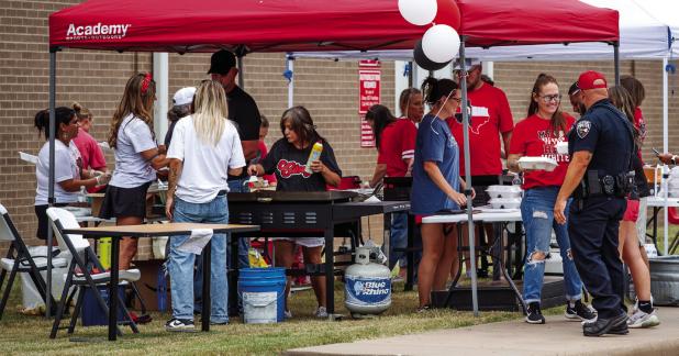 The members of the Olney Athletic Booster Club manned several taco stations, keeping hungry Cubs fans well fed at the Club’s booster event. Photo by Will Sadler
