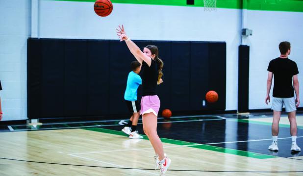 Future Varsity Ladycat is hyper-focused during shooting drills at the Dollar summer basketball camp. Photo by Will Sadler