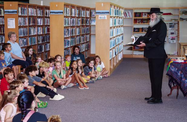 Children of all ages sat spellbound as Ron Wilson the Magician performed his magic act. Photo by Will Sadler