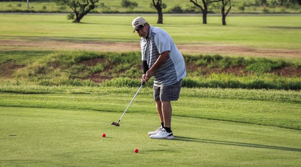 A golfer puts in extra time on the putting green at the Olney Country Club before the CEMCO Tourney gets underway. Photo by Will Sadler