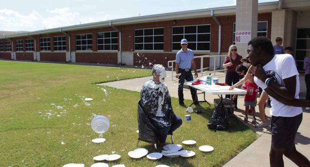 Caleb Fobbs hits Mr. Berngen during the ‘Pie the Principal’ event at Olney Junior High School. Photo by Logan Phillips