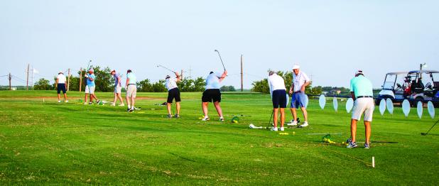 Golfers attending the Olney Country Club’s McClatchy Tourney warm up before tee off on the driving range and putting green. Photo by Will Sadler