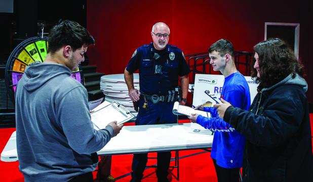 Olney Police Department’s Chief Dan Birbeck hosted a table where seniors could spin a wheel and receive a non-planned bill or hardship, prompting discussions of how to adjust a monthly financial plan. Photo by Will Sadler