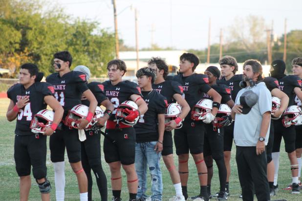 The Olney Cubs Varsity Football team making the Pledge of Allegiance at the start of their Sept. 18 Homecoming victory over the Archer City Wildcats at Cub Stadium. Photo by Kailyn Altmiller