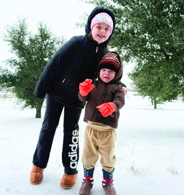 Left: 2-year-old Truett Jones experiencing his very first snow with big sister Morgan