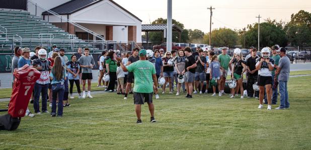 Newcastle ISD Athletic Director and Head Bobcat Football Coach Asiah Archer goes over the importance of the annual tradition of Tackle with Moms. Coach Archer said in part that the event helps show what players go through during practice. Photo By Will Sa