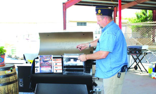 American Legion Post 414 Chaplain Steven Nurre shuffles the raffle tickets at the May 2 drawing at ACE Hardware in Olney. The proceeds of the raffle will help Legion Post 414 carry out its programs. Photo by Gina Keating