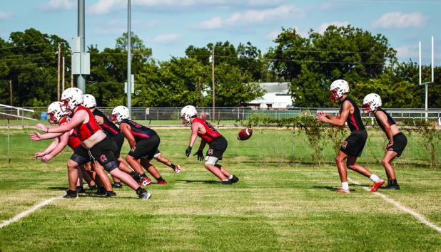 Cub offense works through drills. This season looks to include more passing, which should give this faster Cub team the edge, previous seasons counted on bigger players pushing the Veer offense. Photo by Will Sadler