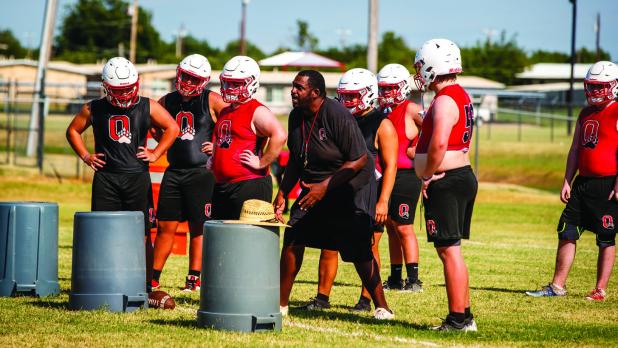 OISD Coach Justin Tate works with the offensive line during afternoon practice. Photo by Will Sadler