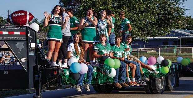 Newcastle High School adorned floats and trailers to proudly parade down Newcastle’s streets during Homecoming Week. Shown are the NHS cheerleaders and Bobcat footballers. See more coverage of parade and game on Page 10 Photo by Will Sadler