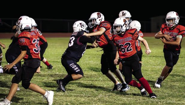 Cub Midget #50 Blaine Owen and #62 Braxton Wales clear the way for the Cub runner. Photo by Will Sadler