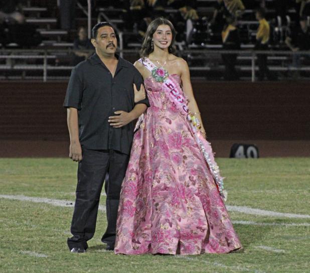 Homecoming Queen nominee Katy Rosales and her father promenade onto the field during halftime at the OHS Homecoming game at Cub Stadium on Sept. 18. Photo by Gina Keating