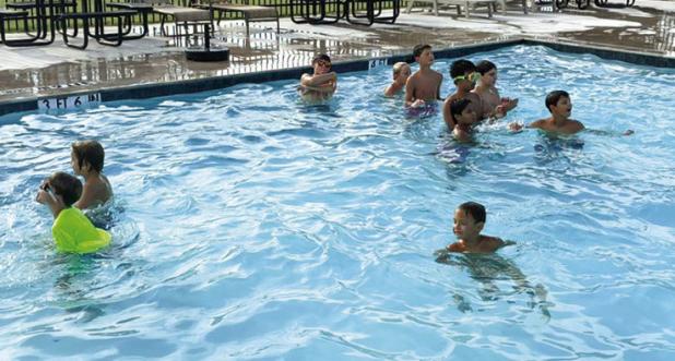 Coach Eric Symank celebrated the successful conclusion of summer basketball camp with a pool party at the Olney municipal swimming pool, which has seen a lot of use since the heat dome settled over the City this month. Photo by Will Sadler
