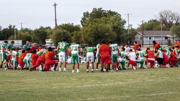 Players and Coaches from the Bobcat, Longhorn, and Yellowhammer scrimmage circle up for fellowship and prayer after the day’s matchup. Photo by Will Sadler
