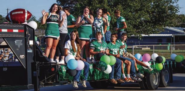 Newcastle High School adorned floats and trailers to proudly parade down Newcastle’s streets during Homecoming Week. Shown are the NHS cheerleaders and Bobcat footballers. Photo by Will Sadler