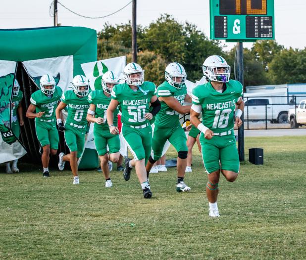 NHS Bobcat #18 Keyton Newland, RB/QB, leads fellow teammates out of the Bobcat tunnel onto the field before the Guthrie match.