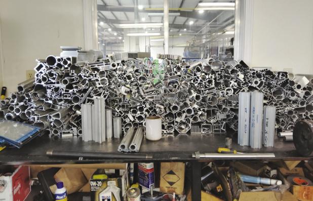 A pile of dies at PSI Extrusion’s plant in Olney. PSI and other Olney manufacturers say business is brisk, despite fears of materials shortages and higher input costs stemming from the U.S.-Iran War. Photo by Gina Keating