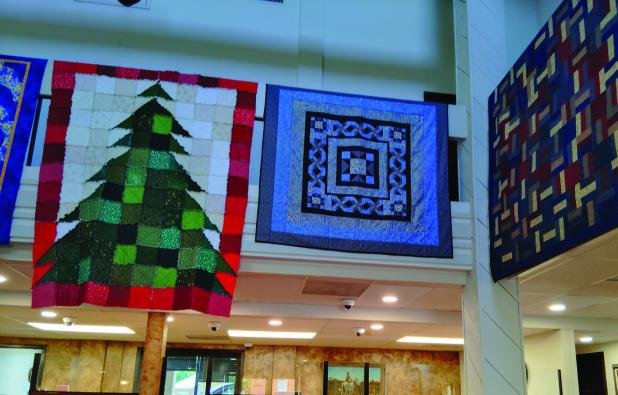 Cross Timbers Stitchers Guild is displaying quilts in the Olney InterBank lobby, and offering several quilts for sale to benefit local charity. Photo by Gina Keating