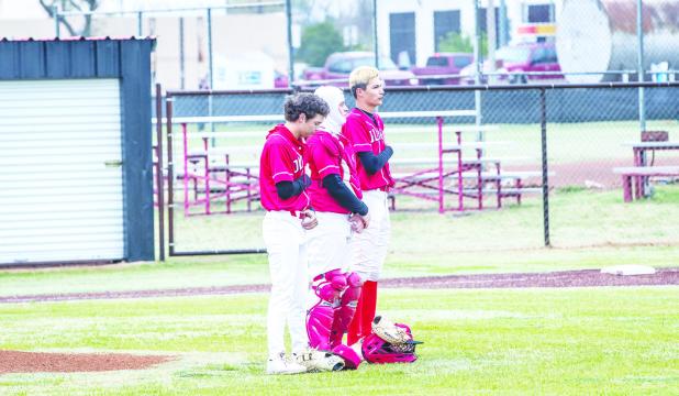 Olney Cubs pause to give respect during the singing of the national anthem before their matchup with the Petrolia Pirates. Photo by Will Sadler