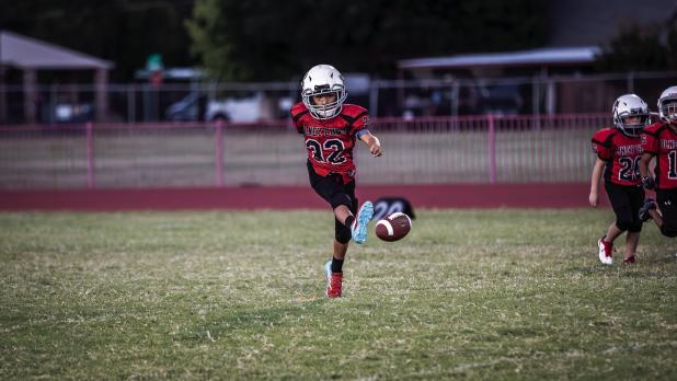 Peewee Cub #32 Lucas Geter performs kicking duty during the Cub-Lion matchup. Photo by Will Sadler