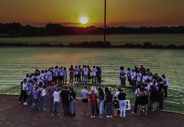 During the annual Senior Sunrise Rise gathering Seniors, parents and organizers gathered in a prayer circle for prayer for the year to come. Photo by Will Sadler