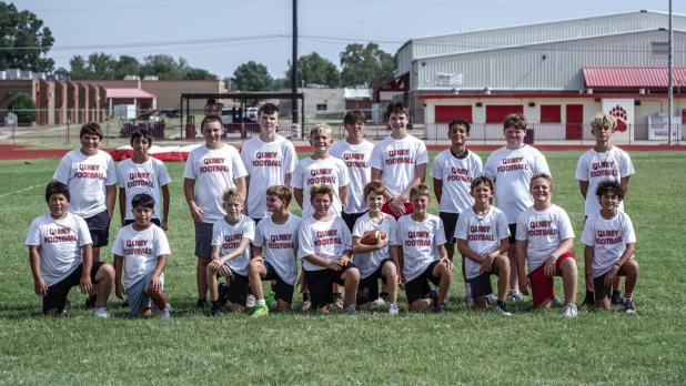 Sixth-ninth grade football camp attendees pose for a team photo. Most of these players have been playing together in backyards and on playgrounds since knee-high. Photo by Will Sadler