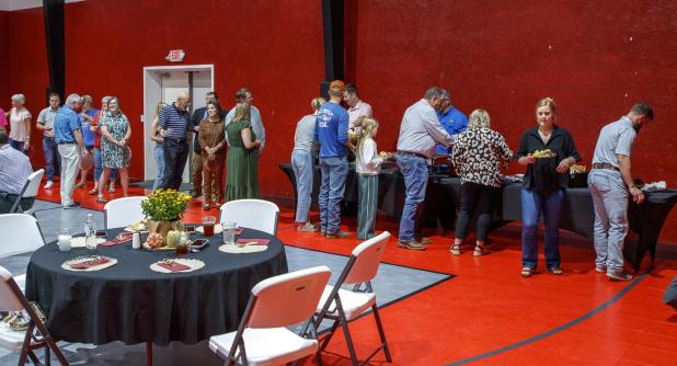 Attendees at The Refuge’s 10th Anniversary celebration lined up for barbecue from Fowler’s BBQ of Throckmorton, which donated its services. Photo by Will Sadler