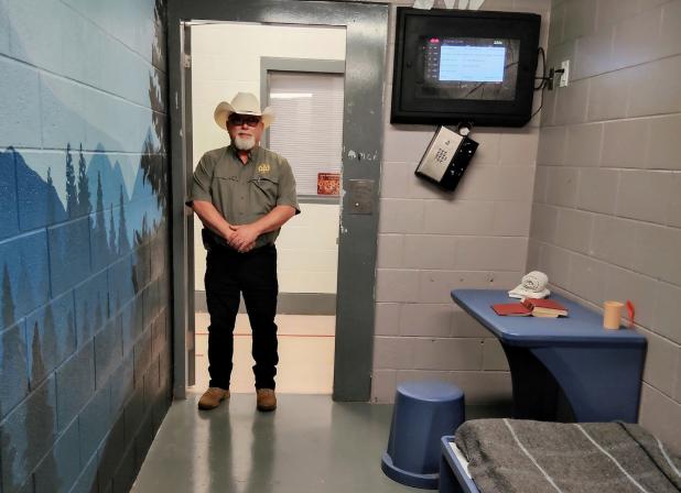 Young County Sheriff Travis Babcock standing in a jail cell specially designed to calm and protect inmates from harming themselves Photo by Gina Keating