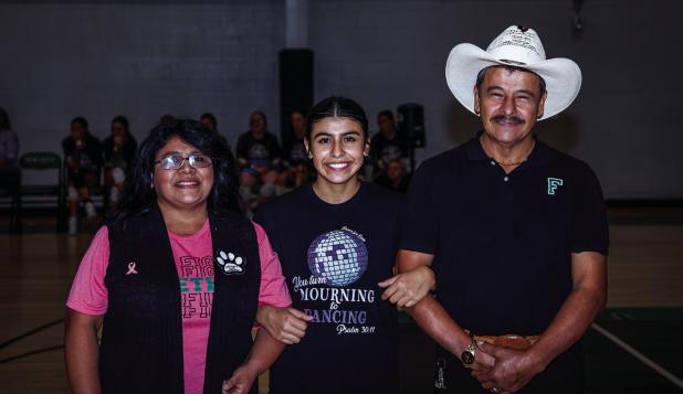Flor is escorted by parents Norma and Lorenzo Carranza during Senior Night. Photo by Will Sadler