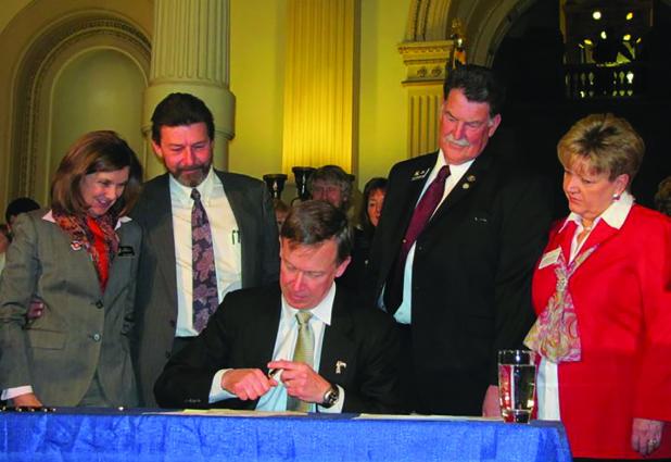 Olney resident Richard Harding, second from right, with wife Debra and Colorado Gov. John Hickenlooper at the signing of a speciality tax for rural hospitals that he championed for Montrose County hospitals. Photo provided by Richard Harding
