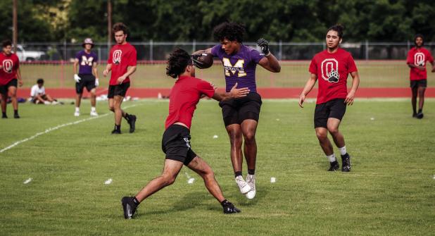 An Olney Cubs Varsity player tags a Munday receiver during a play at the 7 on 7 matchup. Photo by Will Sadler