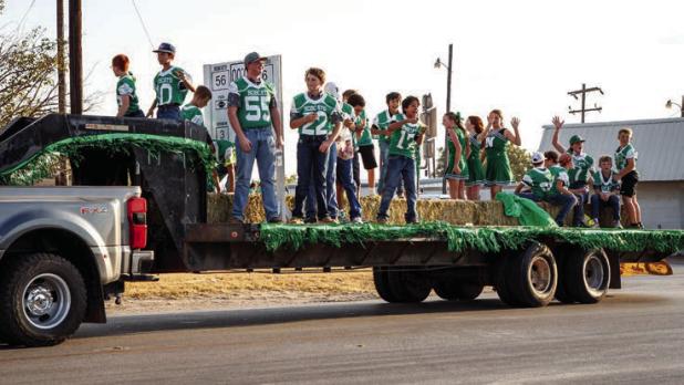 Newcastle Junior High Bobcat football players and cheerleaders show their school pride during the NHS HOCO Parade. | Photo by Will Sadler