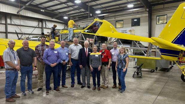 Congressman Roger Williams (in suit and tie, center) met with executives at Air Tractor and Olney leaders on Aug. 25 for a tour of the world’s largest turboprop maker and a town hall with its employees. Photo provided by Office of Rep. Roger Williams