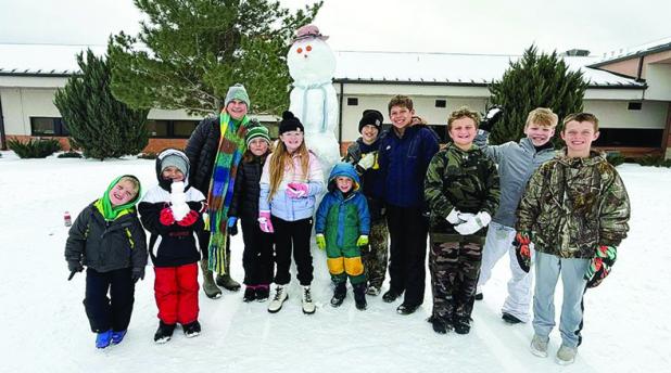 Newcastle Youth banded together to build a snowman in the schoolyard