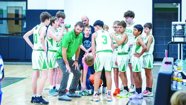 Coach James King gives instructions to the Bobcats early in the match. Photo by Will Sadler