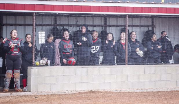 The OHS Lady Cubs didn’t let a cold and drizzly day ruin their fun, cheering on teammates and some good old chatter at the opposing Lady Panthers. Photo by Will Sadler
