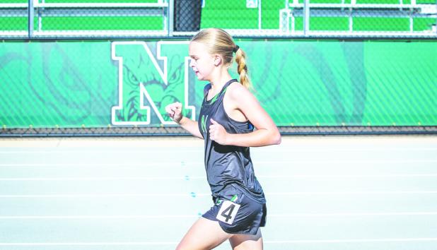 NHS Ladycat Allison Melton led the pack during the NHS Coal Mine Relays on the 3200, earning the first-place finish. Photo by Will Sadler