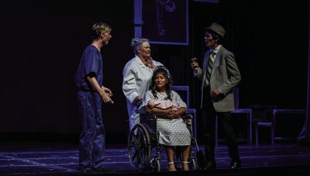Matilda, as a newborn as her parents, doctor and nurse listen to Matilda’s dad, Mr. Wormwood, go on about his latest scheme to make money. Photo by Will Sadler