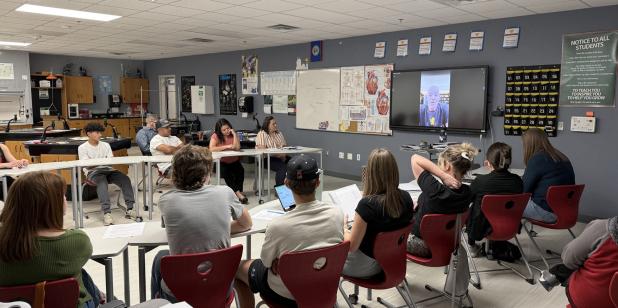 OHS student council and National Honor Society members and their parents watch a videotaped message from Netflix co-founder Marc Randolph, who shared how his experience at NOLS as a student and guide helped him become a successful leader. Photo by Will St