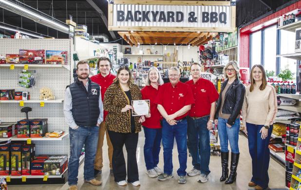 Olney Chamber of Commerce board members Jake Randall, Dan Branum, Chamber director Kimberly Smith, ACE owners Kris, Rand and Jeff Kamp, and Chamber board members Callie Hicks and board president Kaylah Hampton pose for a photo at Olney’s year-old ACE Ha