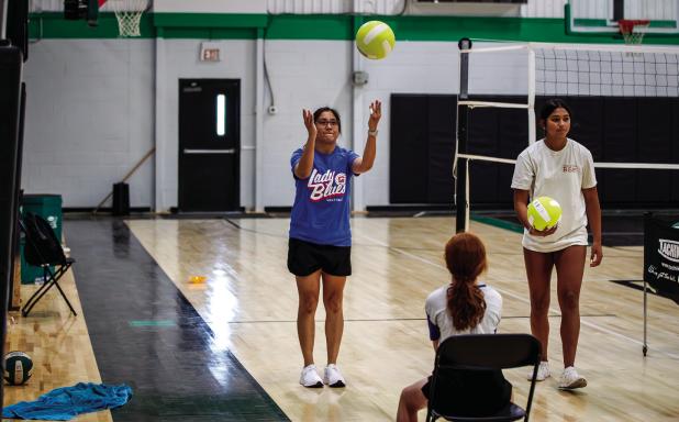 LaTisha Jacoba, mom to Mya, lends a hand during summer volleyball skills class. Photos by Will Sadler