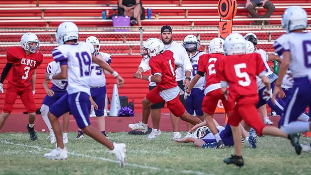 OJH Cub quarterback #1 Santiago Hernandez rolled left out of the pocket and blasted through Plowboy defenders on his way to the end zone for six! Photo by Will Sadler