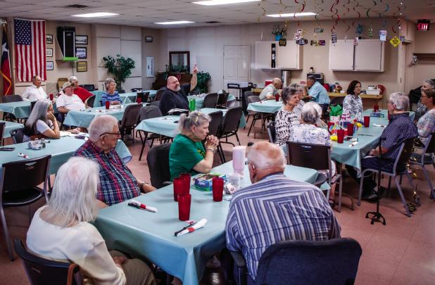 Revelers at the Olney Senior Cub Center gather to wish Edwana Fikes a happy retirement and thanks for her 20 years working the telephones and the desk and serving meals. Photo by Will Sadler