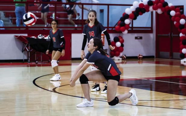 OJH Lady Cub #23 Caroline Stewart gets low to dismantle a kill shot from an opposing Lady Indian. Photo by Will Sadler
