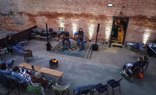 Attendees of the free Archer and Gunn concert celebrating a 5-year anniversary milestone huddle close together under blankets near fires to stay warm, even though the weather was on the chili side attendees didn’t seem to mind at all. Photo by Will Sadl