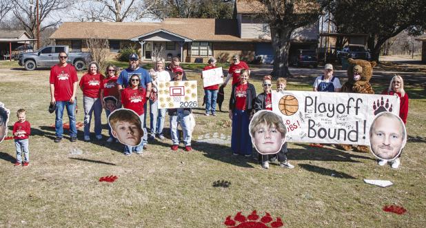 Parents, fans, and community members lined the road with signs and cheering as the Cubs rode past, heading to the Bi-District playoff game. Photo by Will Sadler